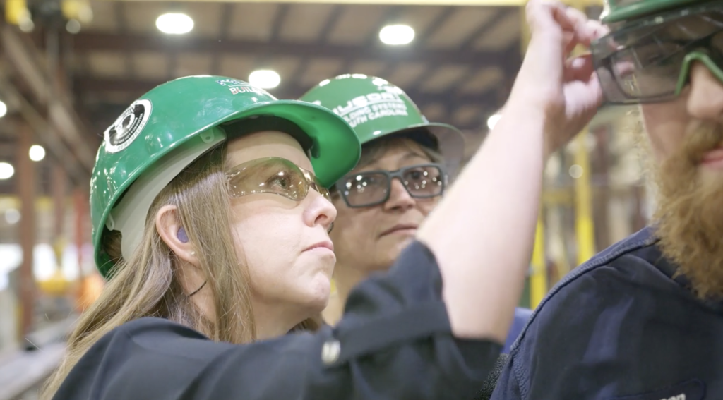 Dr Sarah, audiologist with factory foreman